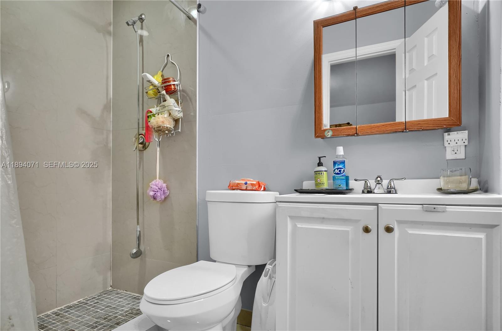 2155 Northwest 28th Street Miami, FL 33142 - Photo 15 of 18 a bathroom with a sink toilet and mirror