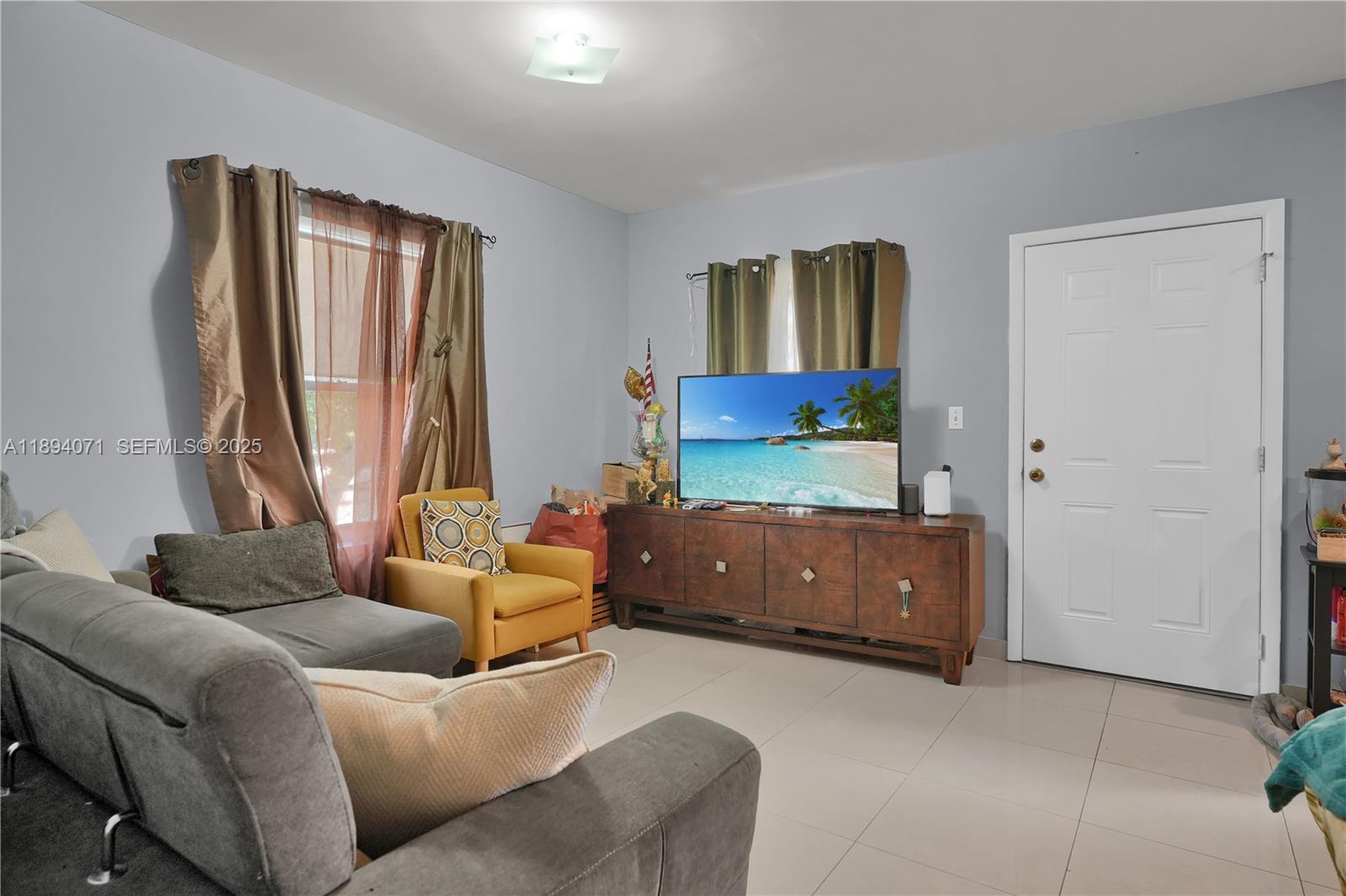 2155 Northwest 28th Street Miami, FL 33142 - Photo 3 of 18 a living room with furniture and a window