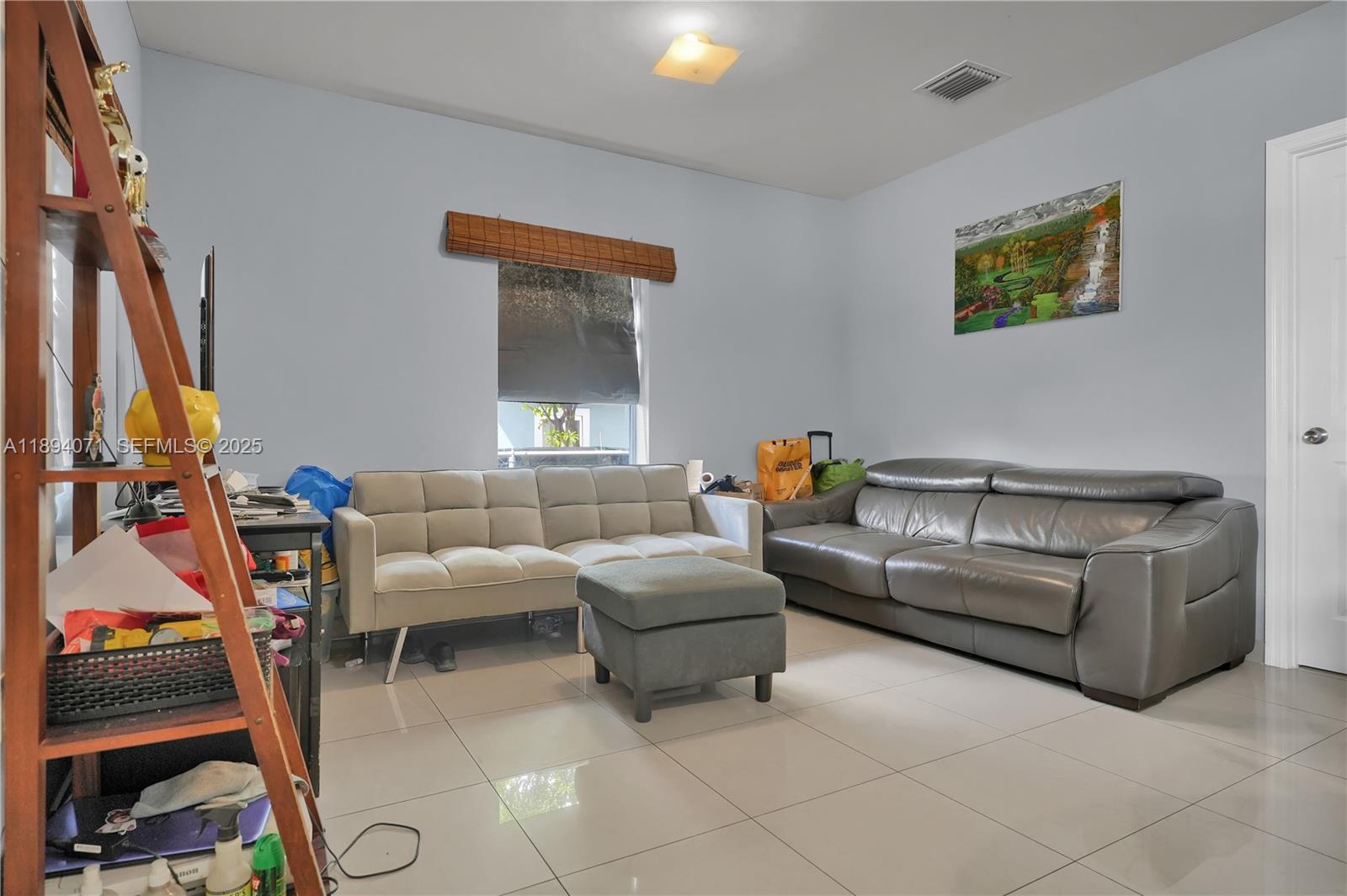 2155 Northwest 28th Street Miami, FL 33142 - Photo 5 of 18 a living room with furniture and a window