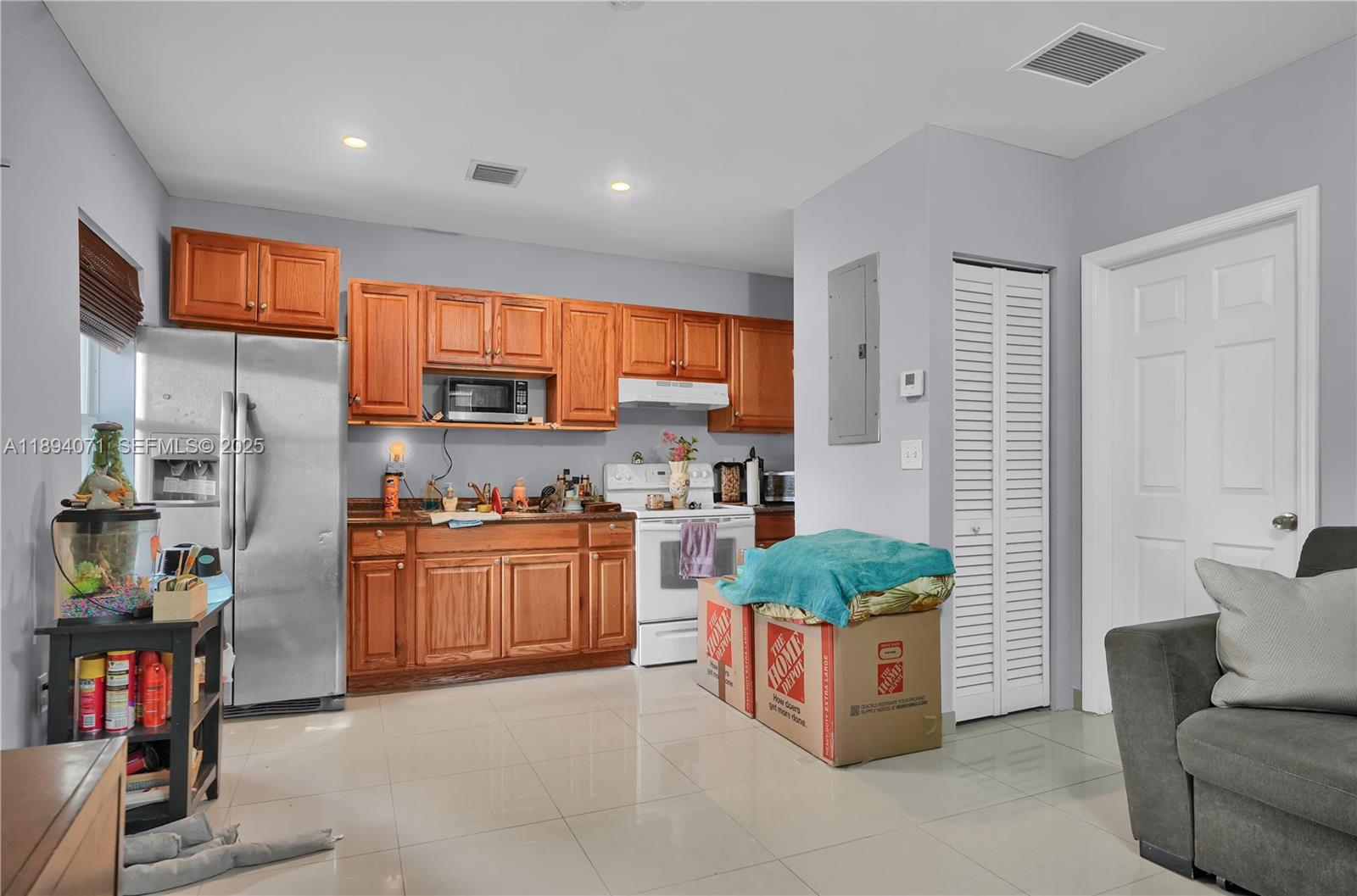 2155 Northwest 28th Street Miami, FL 33142 - Photo 7 of 18 a kitchen with stainless steel appliances granite countertop a refrigerator and a stove