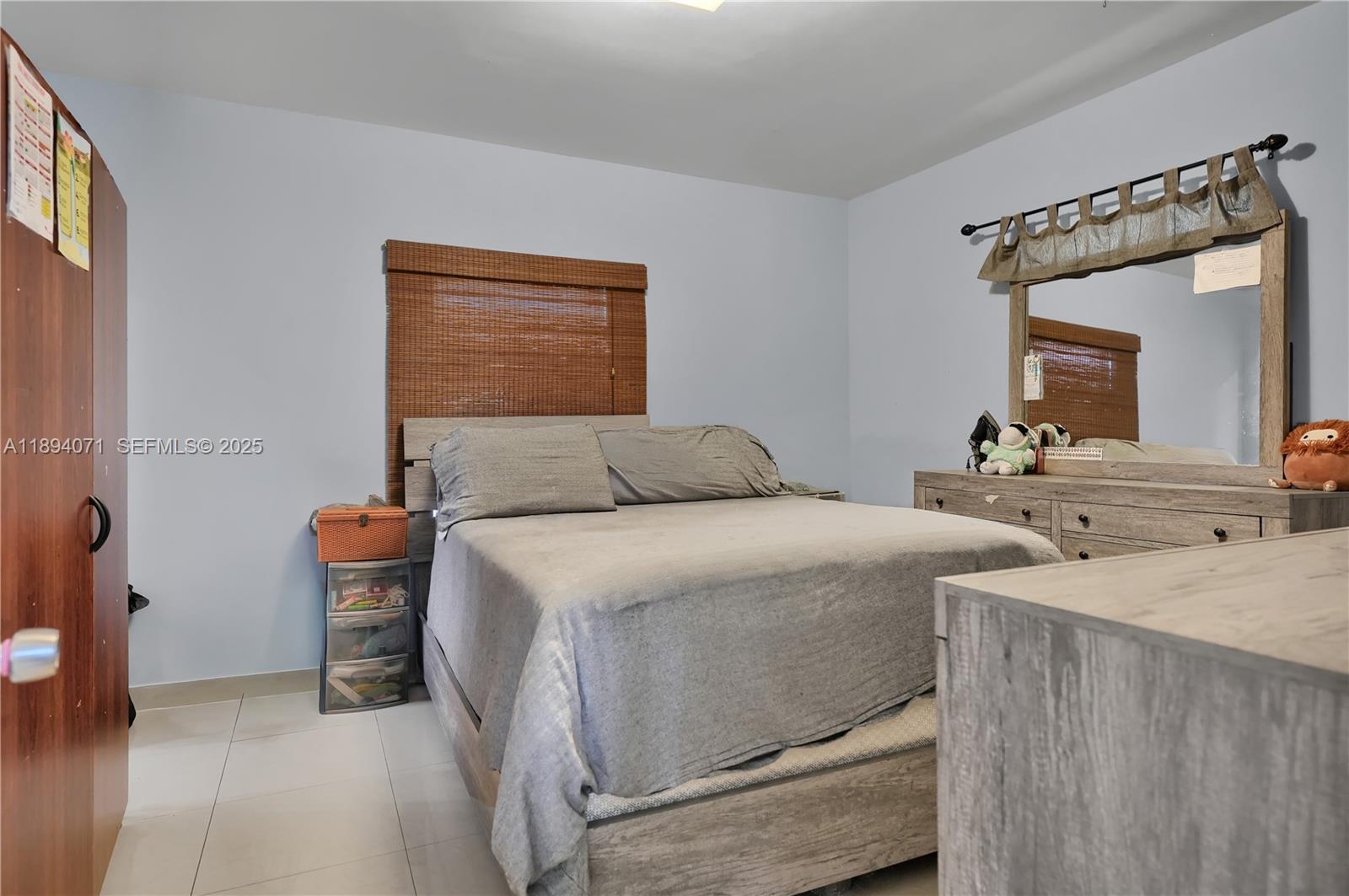 2155 Northwest 28th Street Miami, FL 33142 - Photo 8 of 18 a bedroom with a bed and a table in it