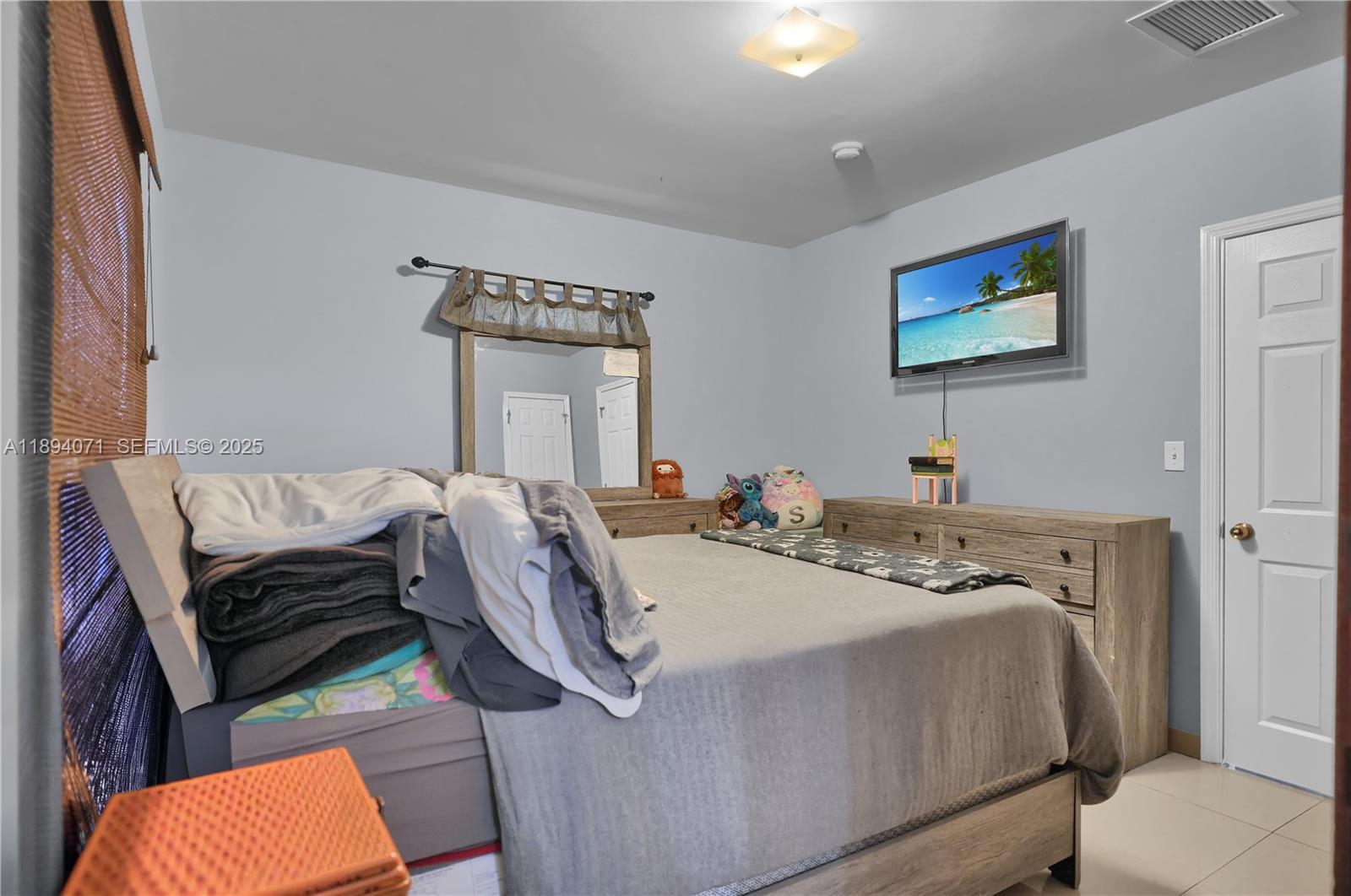 2155 Northwest 28th Street Miami, FL 33142 - Photo 9 of 18 a bedroom with a bed and wooden floor