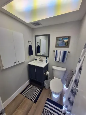 a bathroom with a toilet a sink and a mirror