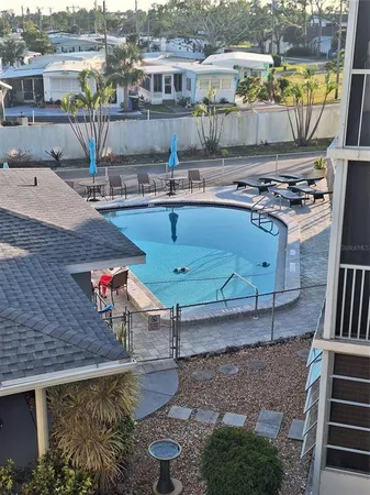a swimming pool with outdoor seating and yard