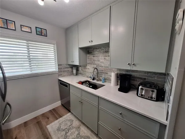 a kitchen with a sink and cabinets