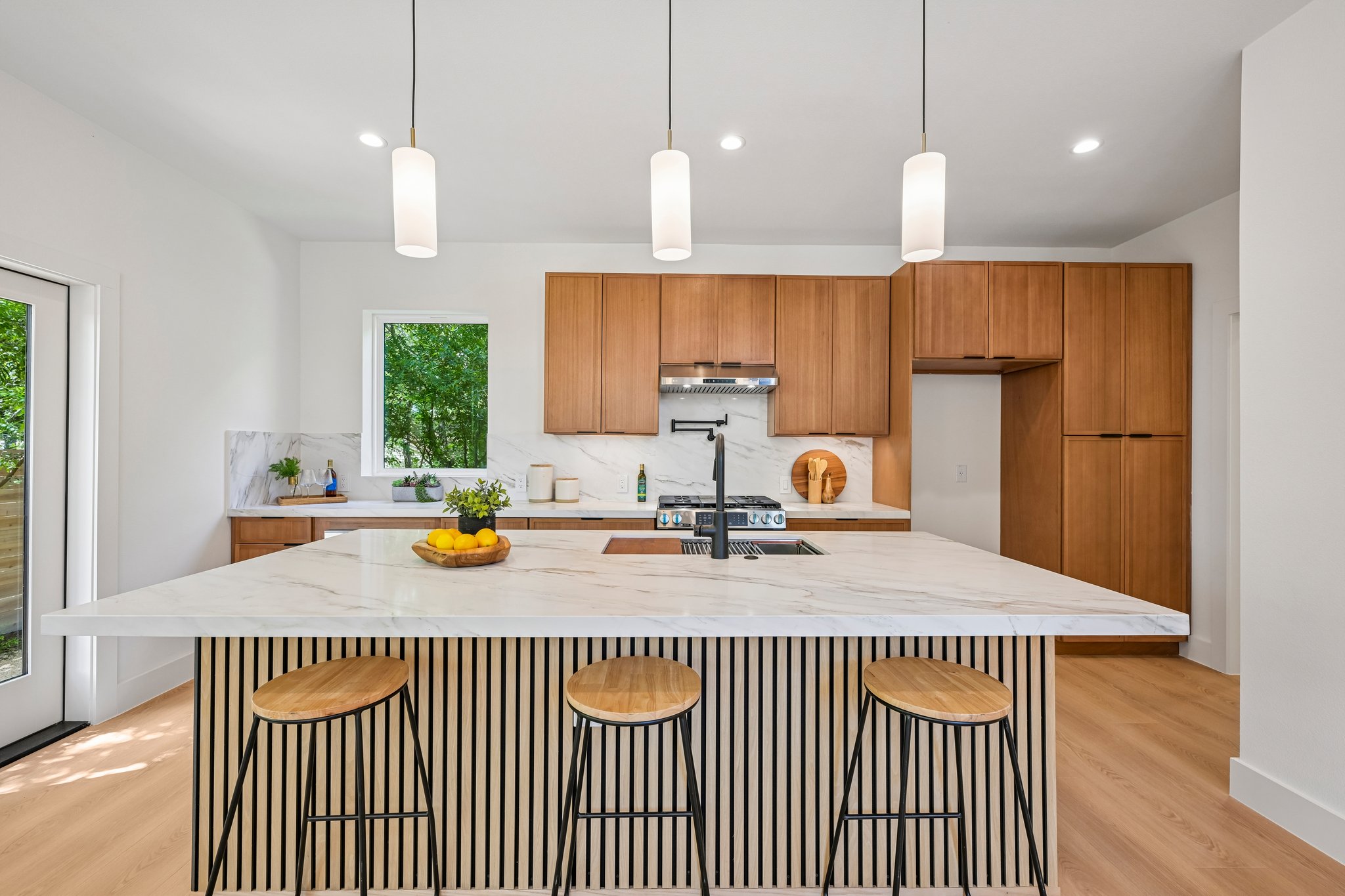513 West Odell Street, Unit B Austin, TX 78752 - Photo 9 of 38 Culinary dreams come alive in this kitchen with a spacious island, complete with pendant lighting.