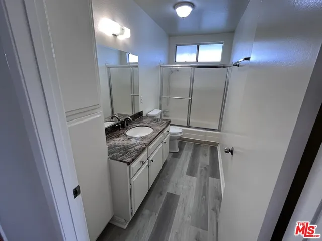 a bathroom with a sink a mirror and a shower