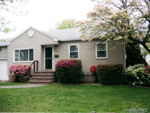 35 Knickerbocker Road South Plainview, NY 11803 - Photo 1 of 1 a front view of a house with a garden
