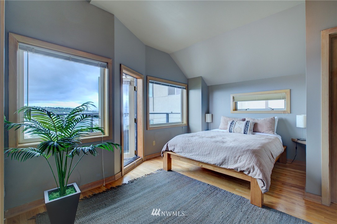 1909 Broadway East Seattle, WA 98102 - Photo 19 of 25 a bedroom with a large bed and a potted plant