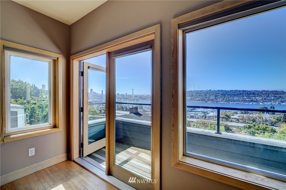 1909 Broadway East Seattle, WA 98102 - Photo 6 of 25 a view of a room with a large window and wooden floor