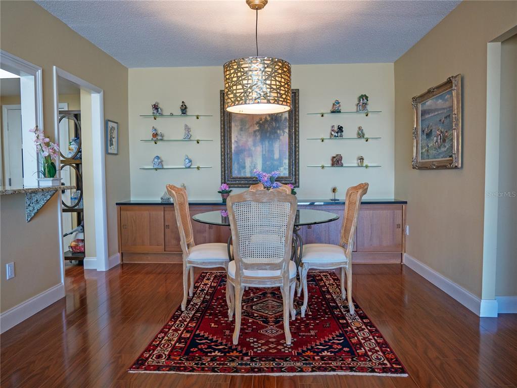 100 Pierce Street, Unit 1301 Clearwater, FL 33756 - Photo 12 of 44 a view of a dining room with furniture window and wooden floor