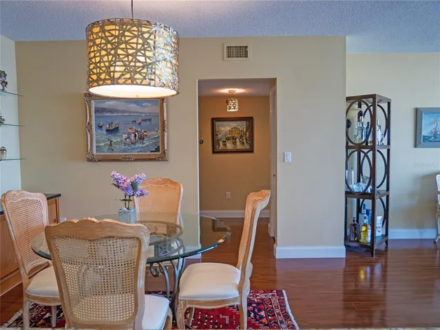a dining room with furniture a window and wooden floor