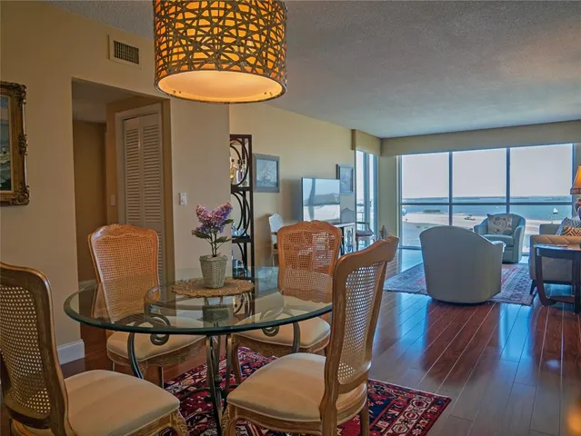 a bathroom with a granite countertop toilet sink and mirror