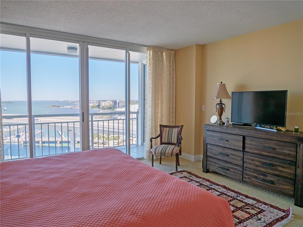 100 Pierce Street, Unit 1301 Clearwater, FL 33756 - Photo 20 of 44 a bedroom with a bed and a television in it