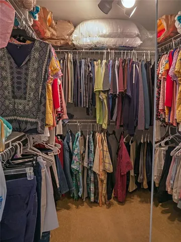 a view of a building with a window and potted plants