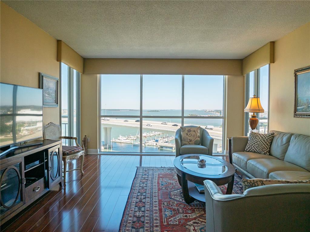 100 Pierce Street, Unit 1301 Clearwater, FL 33756 - Photo 6 of 44 a living room with furniture fireplace and flat screen tv