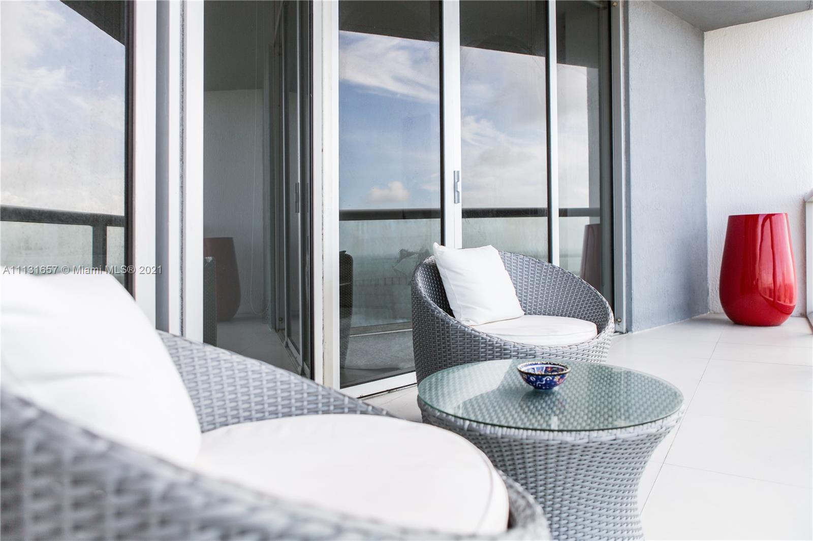 495 Brickell Avenue, Unit 4907 Miami, FL 33131 - Photo 2 of 20 a living room with furniture and a potted plant