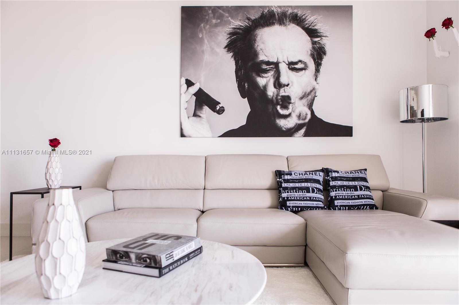 495 Brickell Avenue, Unit 4907 Miami, FL 33131 - Photo 3 of 20 a bedroom with a bed and wall painting