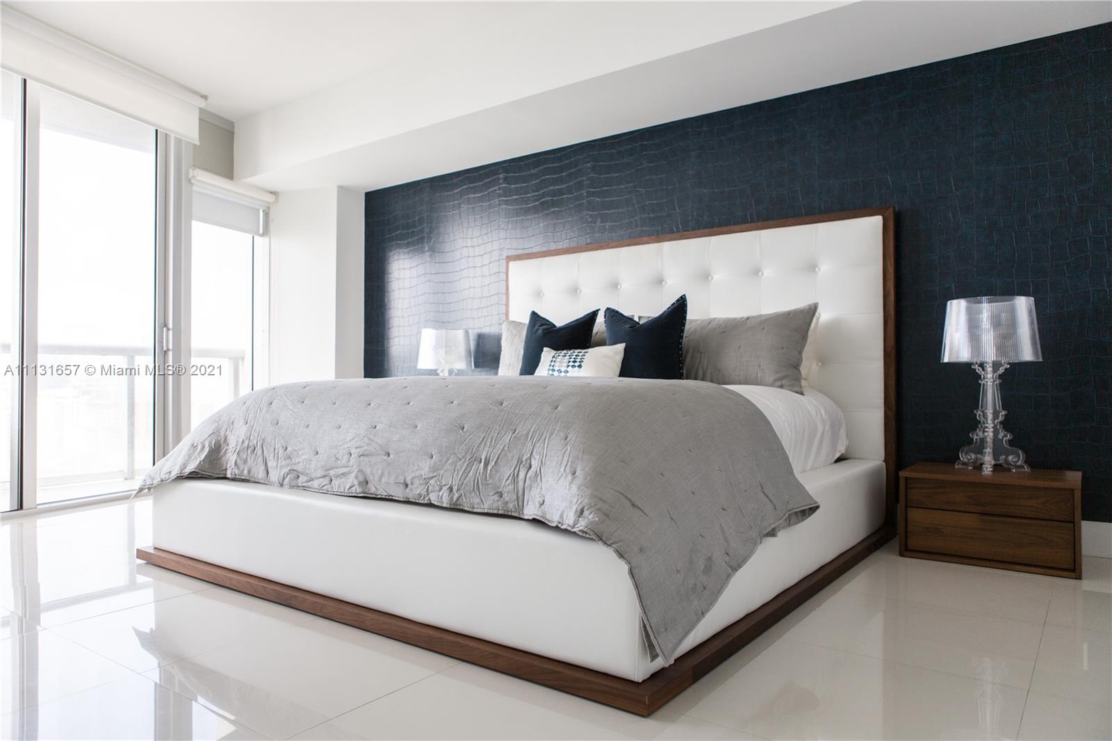 495 Brickell Avenue, Unit 4907 Miami, FL 33131 - Photo 4 of 20 a living room with a bed furniture and a large window