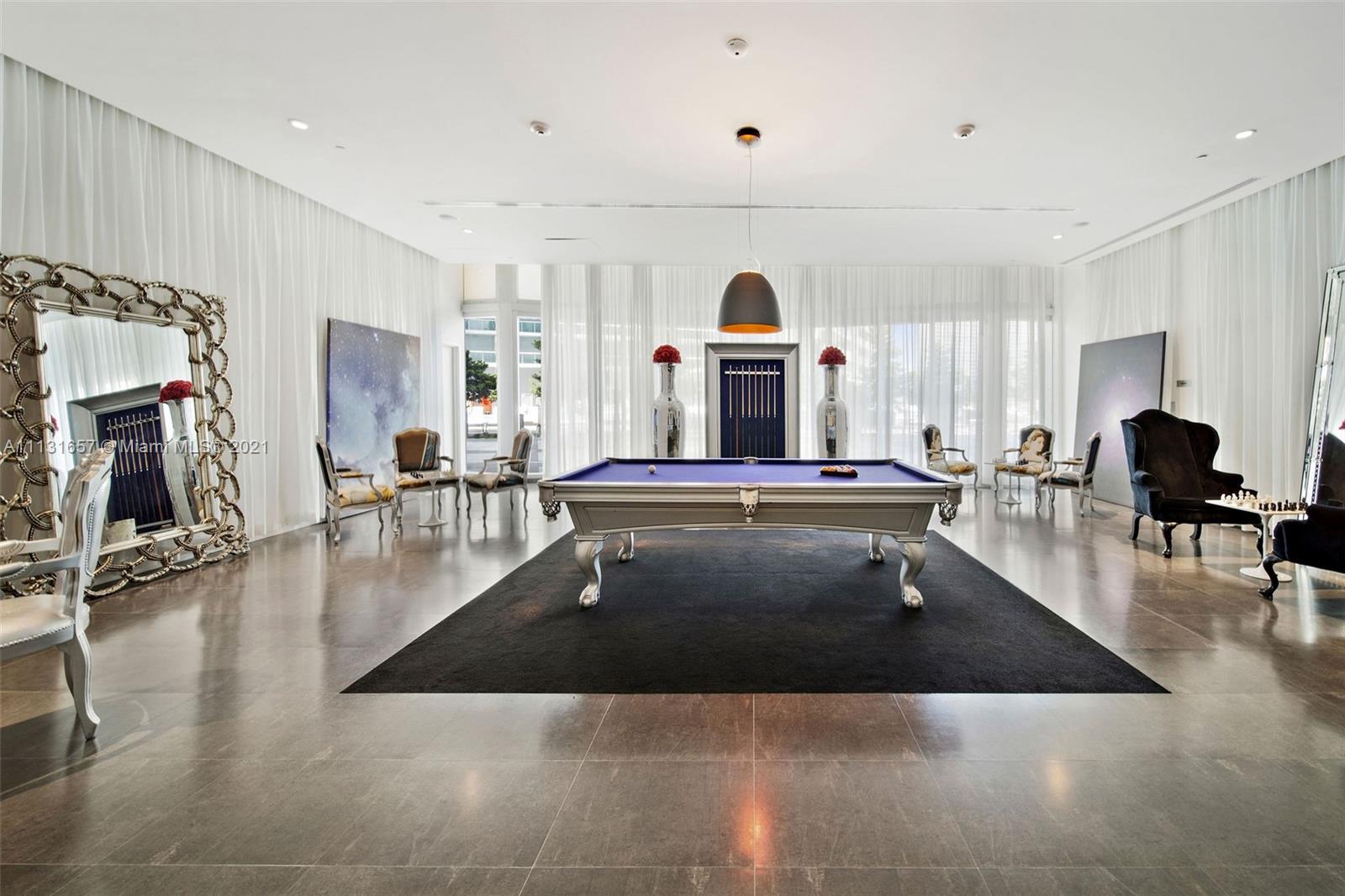 495 Brickell Avenue, Unit 4907 Miami, FL 33131 - Photo 9 of 20 a living room with furniture and a flat screen tv