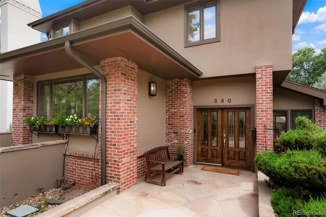 a front view of a house with outdoor seating