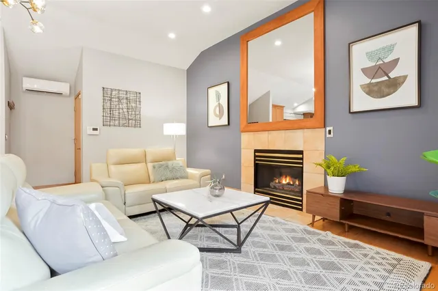 a living room with furniture a table and a fireplace