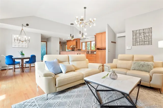 a living room with furniture a chandelier and a chandelier