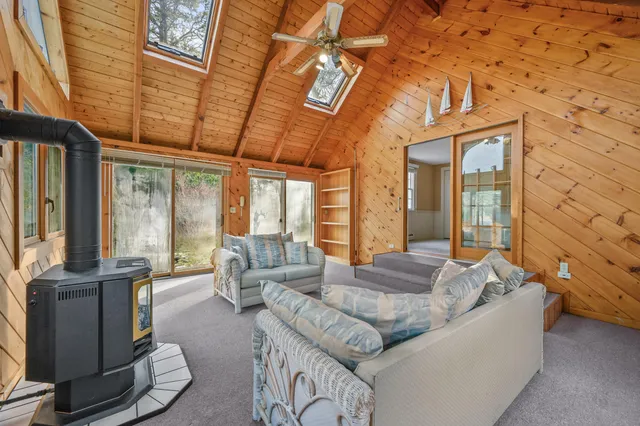 a living room with furniture and large windows