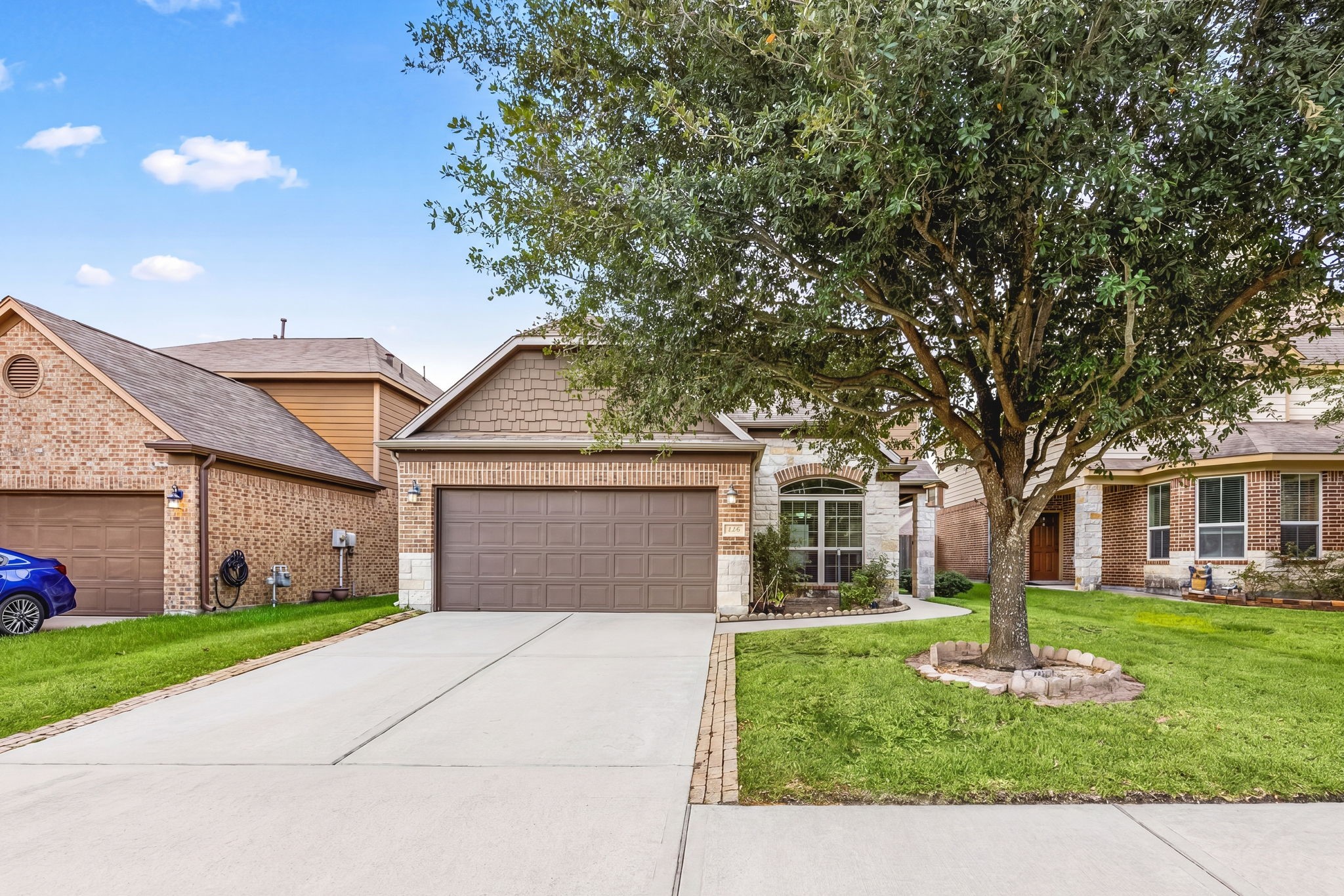 29322 Indian Clearing Spring, TX 77386 - Photo 7 of 47 a front view of a house with a garden and trees