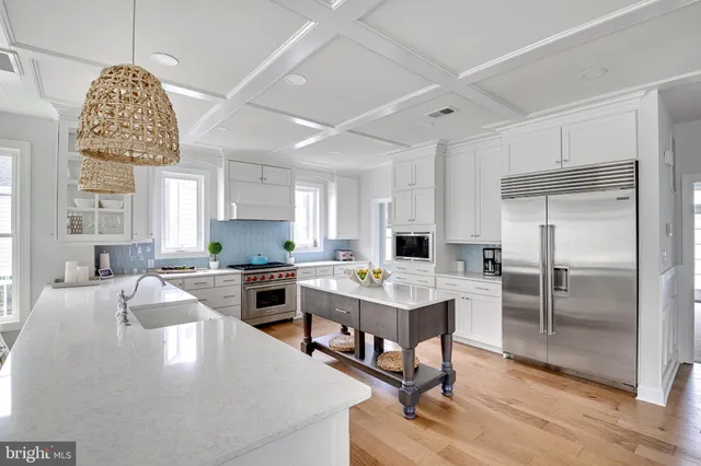 a open kitchen with stainless steel appliances granite countertop a stove refrigerator and cabinets