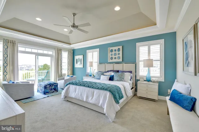 a spacious bedroom with a bed and glass walk in closet