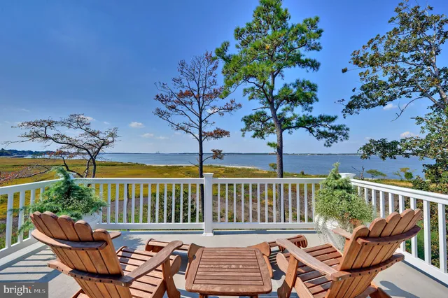 a view of a chair and table on the deck