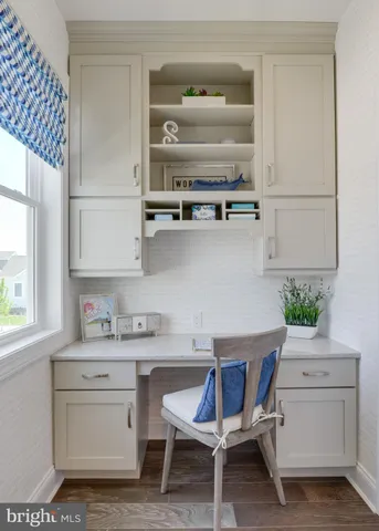 a room with a table chairs and window