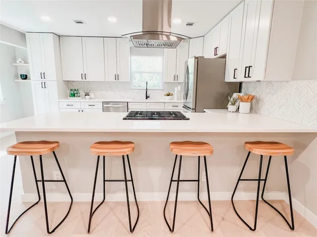 an empty room with wooden floor and ceiling fan