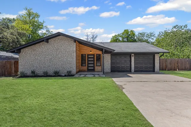 a view of backyard of house and garage