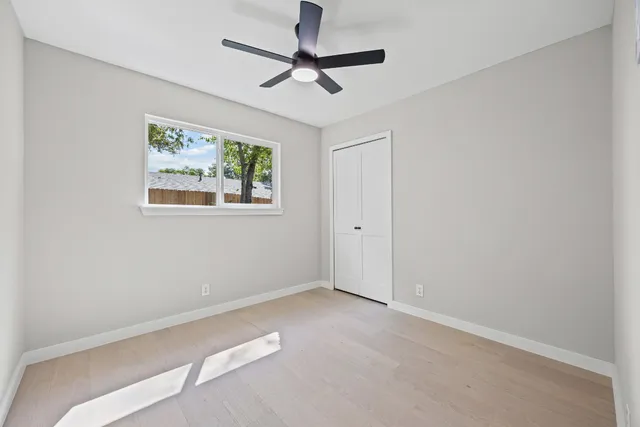 a view of a house with a big yard plants and large trees