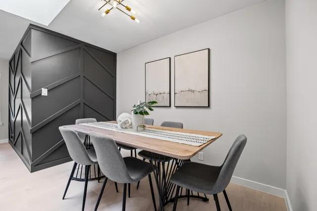 a living room with furniture a chandelier and a window