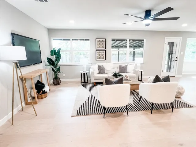 a kitchen with appliances a sink cabinets and wooden floor