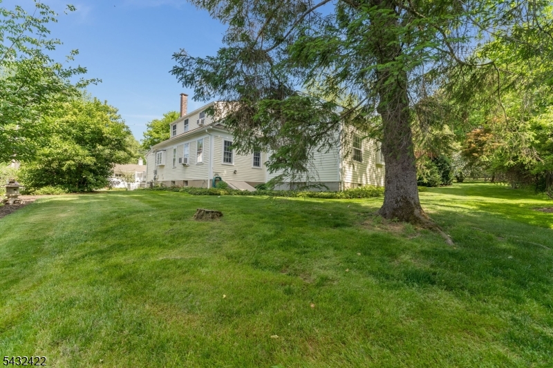11 New Street Mendham, NJ 07945 - Photo 28 of 35 a backyard of a house with lots of green space and fountain