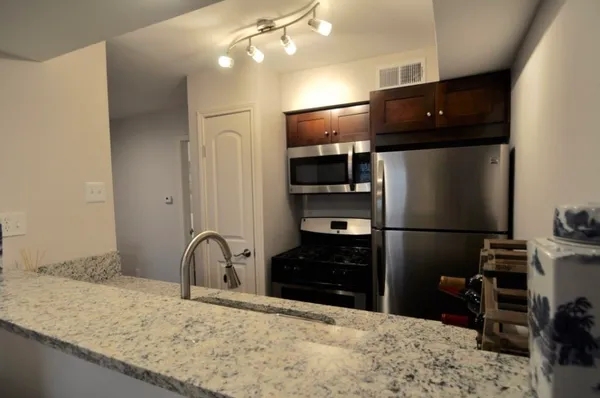 a kitchen with a refrigerator and a sink