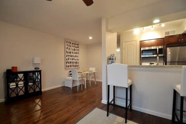a view of a dining room with furniture and wooden floor