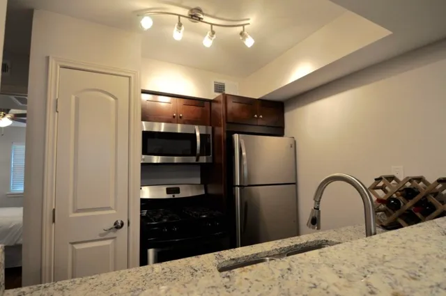 a kitchen with a refrigerator and a sink