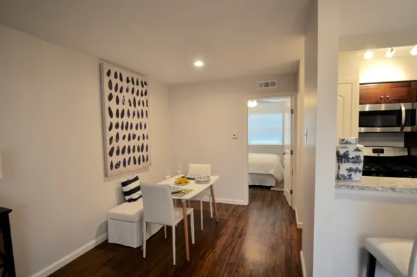 a dining room with furniture and wooden floor