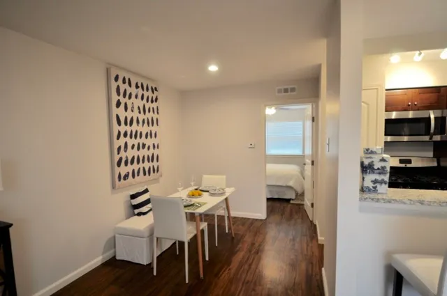 a dining room with furniture and wooden floor