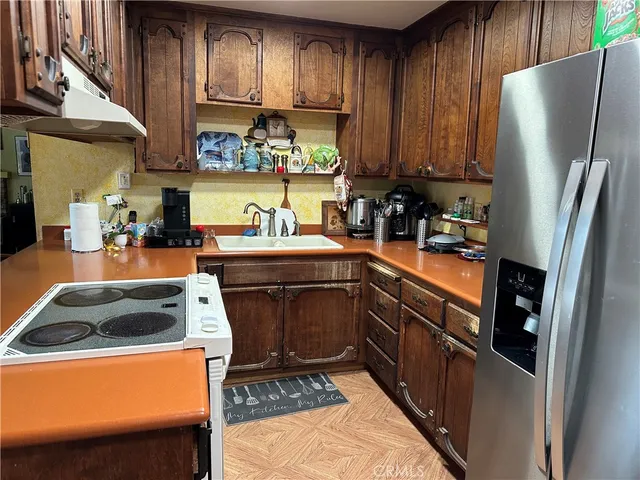 a living room with furniture a fireplace and a chandelier