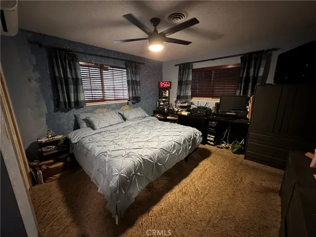 a bedroom with a bed dresser and a window