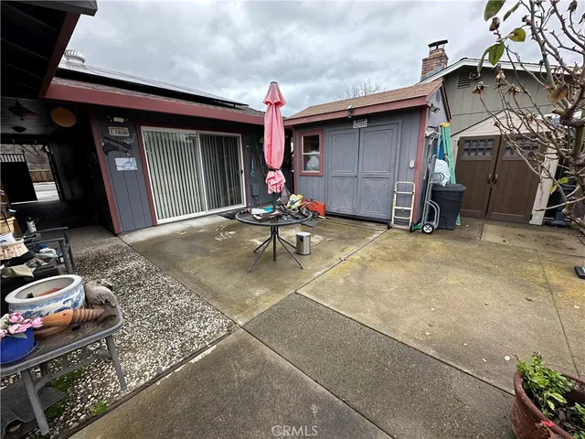 a view of a chair and tables in the patio