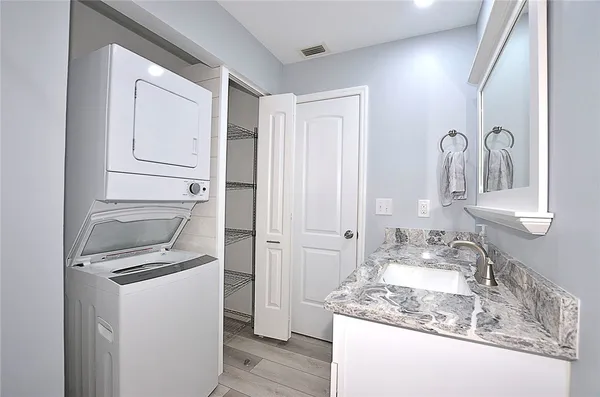 a bathroom with a granite countertop sink and a mirror