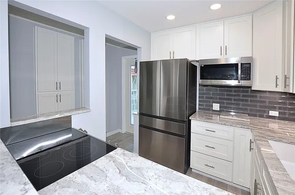 a kitchen with a refrigerator stove and microwave