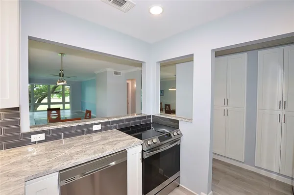 a kitchen with granite countertop a sink and a stove